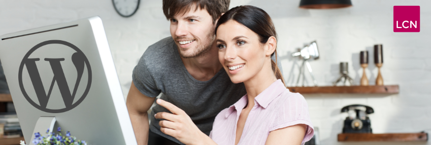 An image of a man and woman, using WordPress hosting on a computer with the WordPress logo on the back.